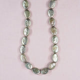 14 mm by 12 mm flat oval green pearls