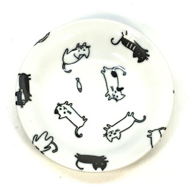 Black and white playful cat sauce dish